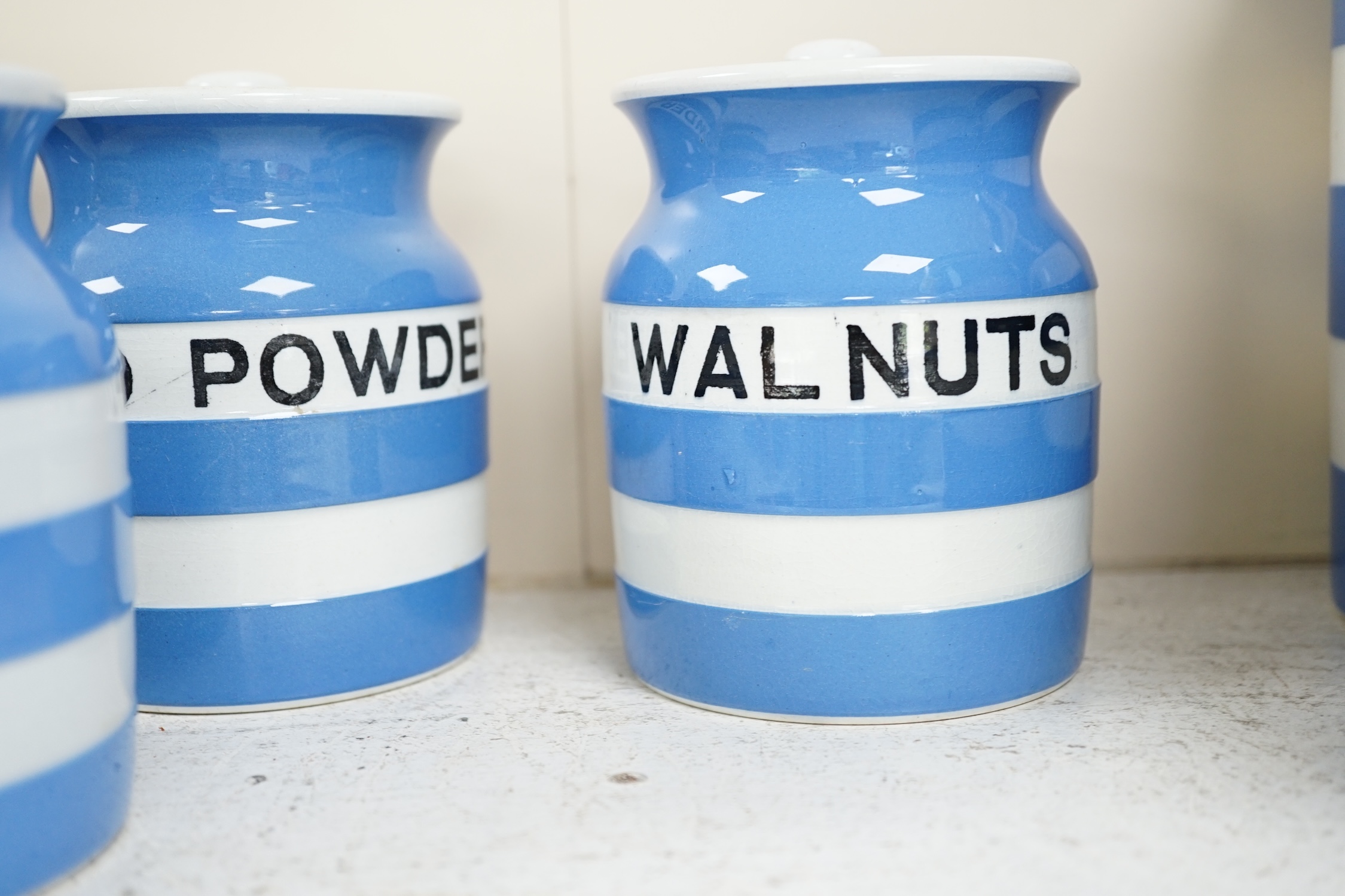 T.G.Green Cornish Kitchenware, ten 12cm and 11cm lidded storage jars to include Pectin, Split Peas, Sesame, Custard Powder and Walnuts, Black Shield marks. Condition - fair to good